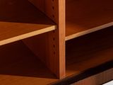 close up of a wooden bookcase with two open shelves on each side