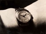 une photo en noir et blanc d'un poignet sur lequel est posée une montre