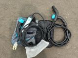 an image of a corded blow dryer sitting on the ground next to a bag