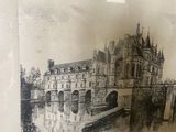 painting of a castle with a bridge in the middle of it