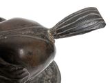 a statue of a bird that is sitting on top of a table