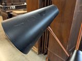 a black lamp that is on top of a table