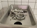 a sink that has a bunch of tools in it