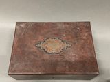 a small wooden box with a decorative design on it