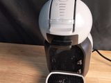 a coffee maker that is sitting on a wooden table