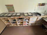a desk with a lot of files and a laptop on it