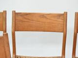 three wooden chairs that are sitting next to each other