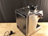 a coffee grinder sitting on a wooden table