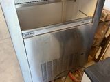 stainless steel counter top oven sitting on top of a wooden pallet