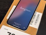 an iphone x in a box on a table with a price tag on it