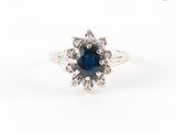 un gros plan d'une bague en saphir et diamants sur fond blanc