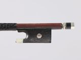 a close up of a violin bow on a white surface