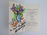 an open book with a drawing of a vase of flowers on it