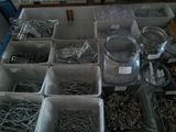 many different types of screws and nails in the bins