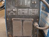 an image of a welding machine sitting on top of a cement floor