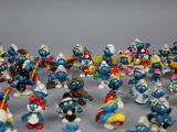 many figurines of different sizes and colors on the table