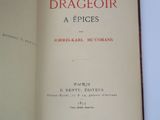 an open book on a table with a picture of a dragon on it