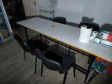 a table with two chairs and a roll of toilet paper on top of it