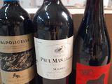 three bottles of wine sitting on top of a wooden box