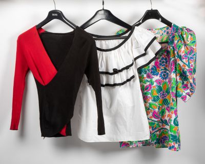 three women ' s shirts hanging on a clothes rack in a closet