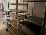 a bunk bed in the middle of a room with a metal shelf
