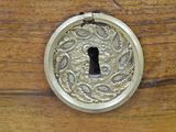 a close up of a keyhole on a wooden door