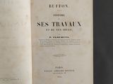a book open on a table with a black background