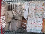 a wire basket filled with lots of papers and scissors