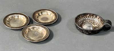 three small silver dishes and a bowl on a table