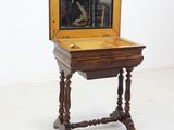 a small wooden table with a mirror on top of it
