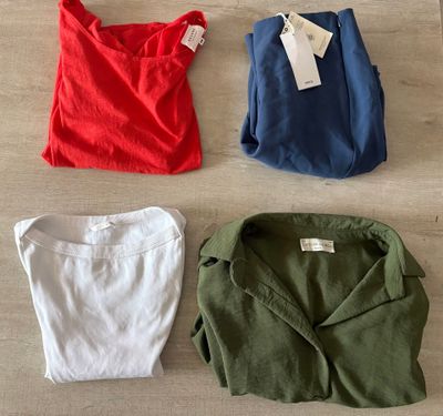 three different colored shirts are laid out on a wooden floor