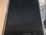 a black stove top sitting in a box on a table