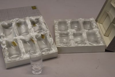a box of empty wine glasses and a glass of water