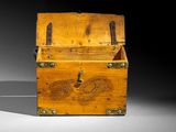 an old wooden chest with a chain hanging from it ' s sides
