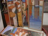 trois tableaux exposés sur une table à côté d'une lampe