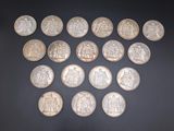 several coins are arranged in a circle on a black surface