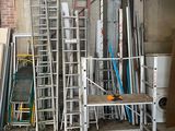 many ladders that are stacked up in a room