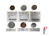 some coins are sitting on a white surface with a barcode