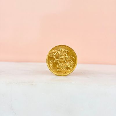 a gold coin sitting on top of a marble counter top