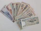 many bills of different colors and shapes on the table