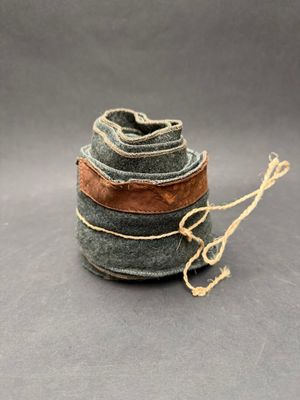 a spool of yarn and a spool of thread on a gray surface