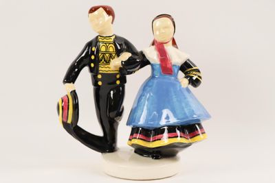 a figurine of a man and a woman holding hands