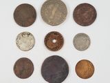 a group of five different types of coins on a white surface