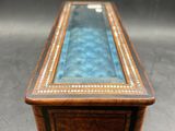 a small wooden box with a blue glass top on a table