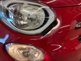 a close up of a car ' s headlight on a red car