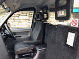 the interior of a vehicle with a seat and a control panel