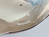 a silver spoon with a hole in the middle of it
