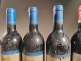 four bottles of wine are lined up on a table