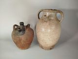 two vases sitting next to each other on a white surface