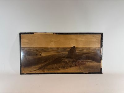 a black and white photo of a desert landscape in a frame